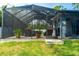 Inviting screened-in patio with comfortable seating, perfect for outdoor relaxation at 13339 Flaherty Ave, Port Charlotte, FL 33981