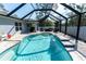 Gorgeous screened-in pool with a seating area for outdoor entertaining and relaxation at 13339 Flaherty Ave, Port Charlotte, FL 33981