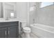 Bathroom featuring a vanity, toilet, and shower-tub combo with tiled walls at 17916 Palmiste Dr, Bradenton, FL 34202