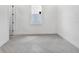 Spacious, empty bedroom with white walls, herringbone flooring, and a window at 17916 Palmiste Dr, Bradenton, FL 34202