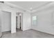 Bright bedroom featuring a tray ceiling, walk-in closet, and large window at 17916 Palmiste Dr, Bradenton, FL 34202