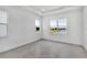 Serene bedroom with tray ceiling, large windows offering a view of the water at 17916 Palmiste Dr, Bradenton, FL 34202