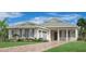 Charming one-story home features a symmetrical design, manicured lawn, and a paver driveway at 17916 Palmiste Dr, Bradenton, FL 34202