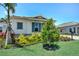 Well-maintained home featuring vibrant landscaping and blue shutters, set against a bright blue sky at 17916 Palmiste Dr, Bradenton, FL 34202