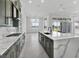 Bright kitchen with modern design, green cabinets, an island, and luxurious quartz countertops at 17916 Palmiste Dr, Bradenton, FL 34202