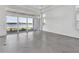 Bright, airy living room with herringbone floors and sliding glass doors overlooking a water view at 17916 Palmiste Dr, Bradenton, FL 34202