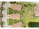 Expansive aerial view showcasing terra cotta tile roofs, lush landscaping, and well-maintained lawns in a vibrant community at 19889 Benissimo Dr, Venice, FL 34293