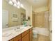 Bright bathroom features a tiled shower and tub combo and a vanity with ample countertop space at 19889 Benissimo Dr, Venice, FL 34293
