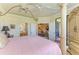 Spacious bedroom with ensuite bathroom access, views of the living room, and access to the pool deck at 19889 Benissimo Dr, Venice, FL 34293