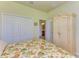 Bedroom featuring a floral comforter, ample closet space, and a decorative armoire at 19889 Benissimo Dr, Venice, FL 34293