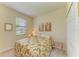 Cozy bedroom featuring a floral comforter, neutral walls, and natural light from the window at 19889 Benissimo Dr, Venice, FL 34293