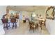 Open floor plan with kitchen bar and dining area featuring chandelier and glass table at 19889 Benissimo Dr, Venice, FL 34293