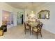 Dining room with a glass table, decorative mirror, and chandelier offering a sophisticated ambiance at 19889 Benissimo Dr, Venice, FL 34293