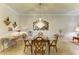 Elegant dining room features a glass table, ornate mirror, and a dazzling chandelier, perfect for entertaining at 19889 Benissimo Dr, Venice, FL 34293