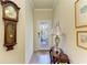 Inviting entryway featuring tile floors, decorative glass door, elegant wall decor, and a charming antique clock at 19889 Benissimo Dr, Venice, FL 34293