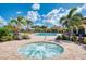 Relaxing hot tub, surrounded by lounge chairs and lush landscaping for a rejuvenating resort style experience at 19889 Benissimo Dr, Venice, FL 34293