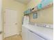Convenient laundry room with a side-by-side washer and dryer and storage shelves at 19889 Benissimo Dr, Venice, FL 34293