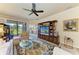 Spacious living room with stylish furnishings, large TV, and serene views of the outdoors at 19889 Benissimo Dr, Venice, FL 34293