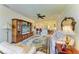 Open living room featuring a large entertainment center, ornate rug, and views into the dining room and kitchen at 19889 Benissimo Dr, Venice, FL 34293