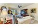 Bright living room featuring cozy seating, entertainment center, and access to the lanai at 19889 Benissimo Dr, Venice, FL 34293