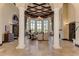 Stunning lobby with soaring ceilings, elegant chandelier, travertine floors, and cozy seating areas at 19889 Benissimo Dr, Venice, FL 34293