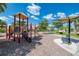 Community playground with a covered picnic area and walking path; offering a safe and enjoyable space for children at 19889 Benissimo Dr, Venice, FL 34293