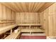 Beautifully wood-paneled sauna with multi-tiered seating and a traditional bucket at 19889 Benissimo Dr, Venice, FL 34293