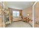 Cozy sitting room featuring a daybed, chairs, and a decorative cabinet at 19889 Benissimo Dr, Venice, FL 34293