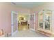 Sitting room leading into the dining room with a decorative cabinet at 19889 Benissimo Dr, Venice, FL 34293