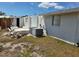 Exterior image of the back and shows an overgrown backyard and other signs of wear and tear needing repairs at 2061 Georgia Ave, Englewood, FL 34224
