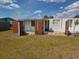 Image of the backyard that has overgrown grass, and partial fencing and showing some exterior issues at 2061 Georgia Ave, Englewood, FL 34224