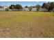 View of a vacant lot with some overgrown vegetation and a white fence in the background at 2061 Georgia Ave, Englewood, FL 34224