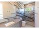 Bathroom featuring a marble accent wall, glass shower, and a gray vanity with an undermount sink at 2375 Floyd St, Sarasota, FL 34239