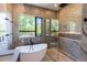 Sleek bathroom with glass shower enclosure and a standalone tub with a great view at 2375 Floyd St, Sarasota, FL 34239
