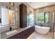 Contemporary bathroom featuring dual sinks, a soaking tub, and marble accents at 2375 Floyd St, Sarasota, FL 34239