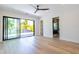 Bright bedroom with wood floors, large glass sliding door, and ensuite bath at 2375 Floyd St, Sarasota, FL 34239