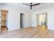 Spacious bedroom boasts hardwood floors, a modern ceiling fan, and ensuite bath access at 2375 Floyd St, Sarasota, FL 34239