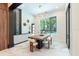 Bright dining room with elegant lighting, view to backyard pool, and modern decorative features at 2375 Floyd St, Sarasota, FL 34239