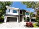 Stunning modern home featuring a paved driveway, two-car garage and striking black and white design at 2375 Floyd St, Sarasota, FL 34239