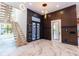 Grand foyer with a modern staircase, designer lighting, and stylish feature wall at 2375 Floyd St, Sarasota, FL 34239