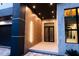 Modern home entrance featuring wood facade, marble accents, and custom lighting at 2375 Floyd St, Sarasota, FL 34239