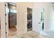 Hallway with laundry closet and access to a modern bathroom with glass shower at 2375 Floyd St, Sarasota, FL 34239