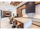 Open-concept kitchen featuring marble island with bar stools and views into the living room at 2375 Floyd St, Sarasota, FL 34239