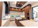 Modern kitchen with wood cabinets, marble countertops, and a sleek design with stylish bar seating at 2375 Floyd St, Sarasota, FL 34239