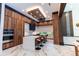 Contemporary kitchen with dark wood cabinetry, a marble island, and counter seating at 2375 Floyd St, Sarasota, FL 34239
