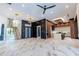 Open-concept living space with marble floors, wooden staircase, and a modern kitchen with a marble island at 2375 Floyd St, Sarasota, FL 34239