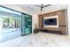Open-plan living area with sliding glass doors opening to the pool and decorative feature wall at 2375 Floyd St, Sarasota, FL 34239