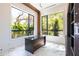 Bright office space with built-in shelving, large windows, and a sleek black desk at 2375 Floyd St, Sarasota, FL 34239