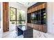 Modern office space with a built-in unit, sleek desk, and views of the lush outdoors at 2375 Floyd St, Sarasota, FL 34239