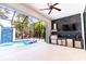 Screened-in outdoor kitchen with built-in grill and view of the pool at 2375 Floyd St, Sarasota, FL 34239